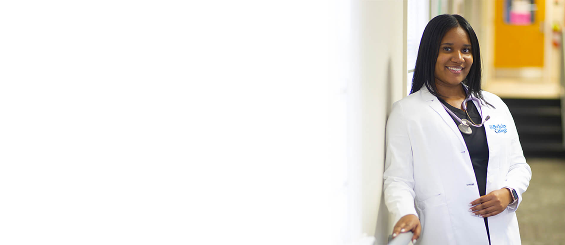 Image: Berkeley Collage nursing student in white scrubs smiling
